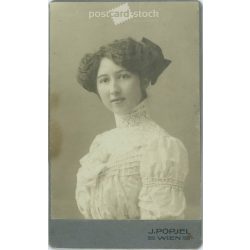   J. Popjel Photo Studio, Vienna. Portrait of young elegant lady with bow hairstyle in lace neck dress. Early 1900s. (2791797)