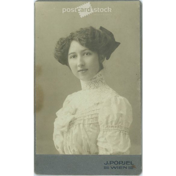 J. Popjel Photo Studio, Vienna. Portrait of young elegant lady with bow hairstyle in lace neck dress. Early 1900s. (2791797)