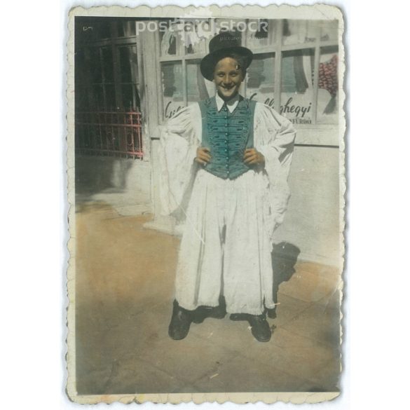 Young boy in traditional costume in front of the Csillaghegy Bath. Color paper image. (2791832)