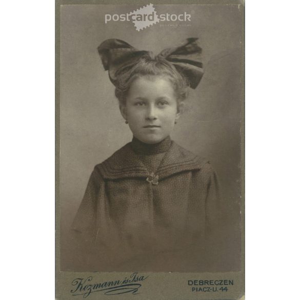 Portrait photo of young girl with huge bow from Kozmann and Companion’s photo studio. Debrecen. Cabinet photo / hardback photo / business card. (2791871)