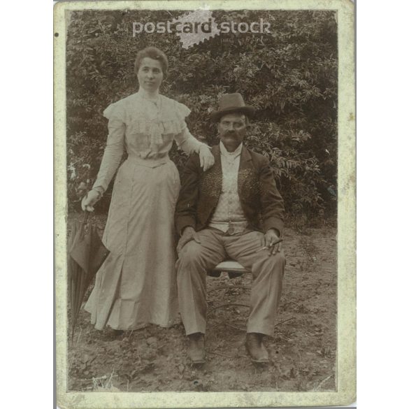 Full-length photo of a middle-aged American couple in the garden. Original paper image, hardback photo. (2791896)