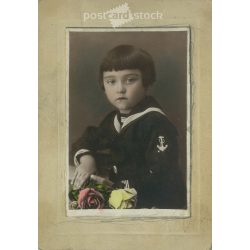   Artistic portrait photo of little boy in sailor top with flowers. Colored paper image. (2791963)