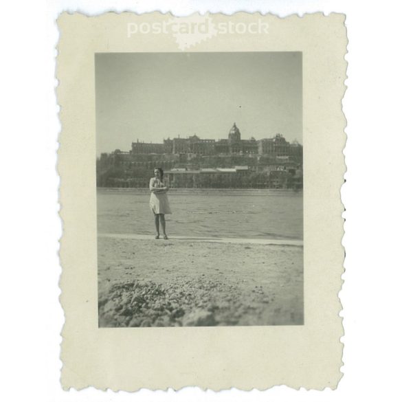 Young woman on the bank of the Danube after the liberation, with the bombed-out Buda Castle in the background. Original small paper image. (2792015)