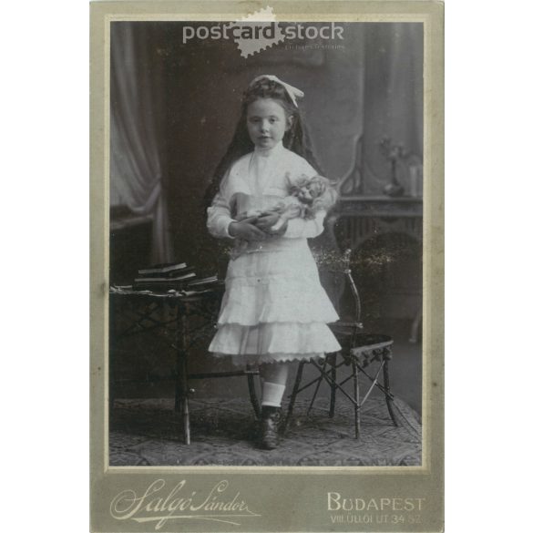 Early 1900s. Photography studio of Sándor Salgó, Budapest. Full-length studio photo. A little girl with a baby in an elegant outfit, with a bow in her hair. Cabinet photo / hardback photo / business card, CDV photo. (2792119)