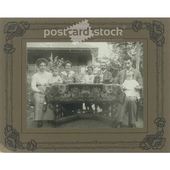 1910s. Family garden party. Covered photo, on cardboard framed with an art nouveau motif. Original paper image. (2792121)