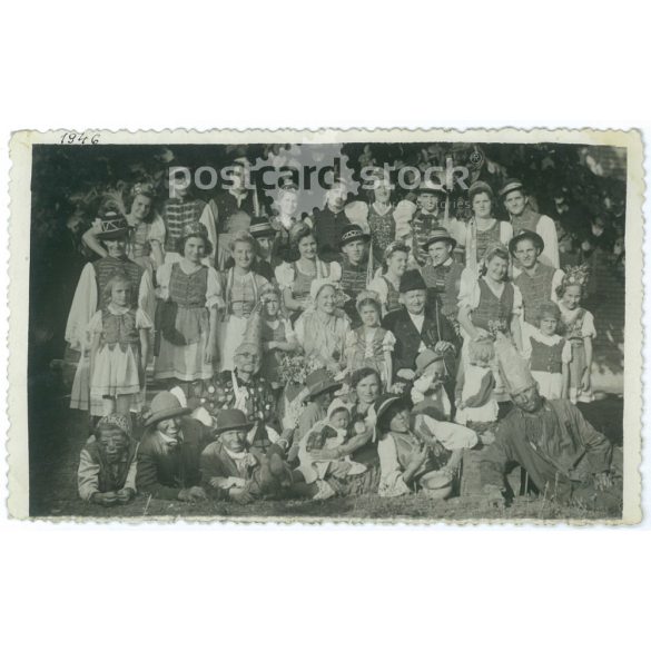 1946 – Group photo taken at a village party, with fun costumers and children. (2792165)