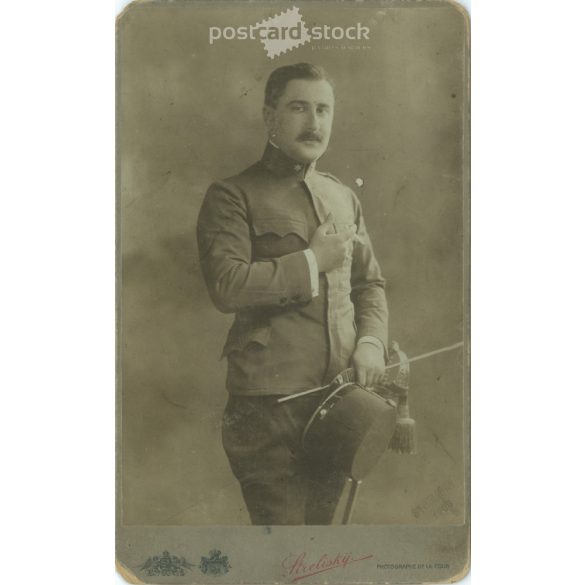 Early 1900s. Man in uniform with cigarette, studio shot. It was made by Sterlisky’s photography studio in Budapest. Original cabinet photo / hardback photo / business card, CDV photo. (2792237)