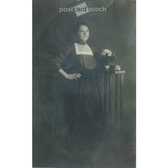 1940s. Full-length photo of an unknown young woman with a flower. Made in the Baross photography studio. Budapest, Baross street. Photo sheet, postcard. Original paper image, gelatin silver. (2792277)