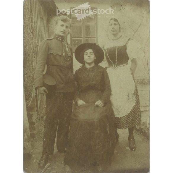 1910s. Family photo in front of the house. Presumably it depicts three brothers. The photographer is unknown, the photo was taken in Hungary. Original paper image. Old postcard, photo sheet. Cut. (2792370)