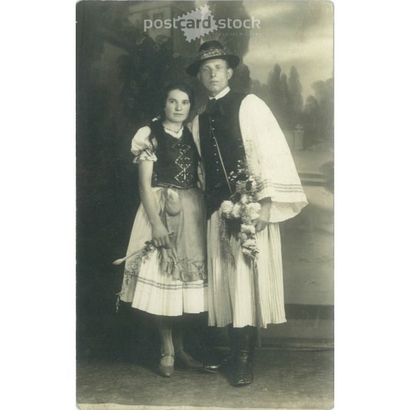 1910s. Young couple in national costume. Made in the Koncz photography studio in Dombóvár. Black and white paper image. Old postcard, photo sheet. (2792375)