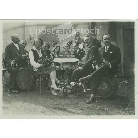 1930s. Cheerful, wine-drinking people. Black and white original paper image, old photo. (2792405)