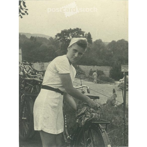 1950s. Young, sporty lady with a bicycle. Its maker is unknown. Black and white original paper image, old photo. (2792420)