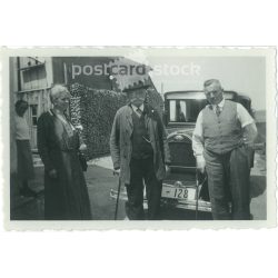   1950s. Germany. Family photo, elderly people standing in front of the car. The creator of the image is unknown. Black and white original paper image, old photo. (2792431)