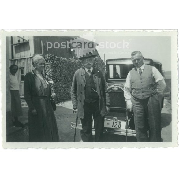 1950s. Germany. Family photo, elderly people standing in front of the car. The creator of the image is unknown. Black and white original paper image, old photo. (2792431)