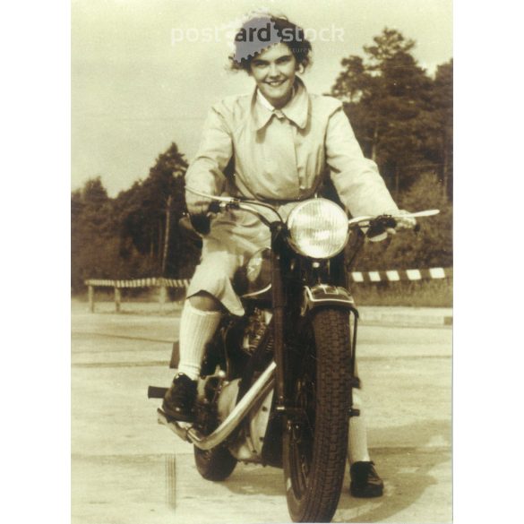 1950s. Germany. Young woman on a motorcycle. Published by Gutsch Verlag, Berlin. Cut out postcard. Black and white reprint from an old photo. (2792443)