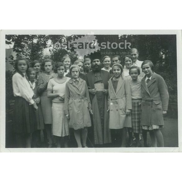 1932. Germany. Young girls with priest. Black and white original paper image, old photo. (2792463)