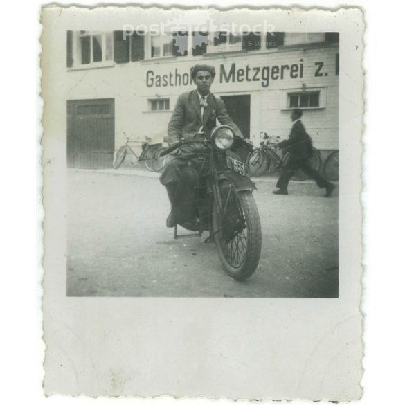 1920s. Germany. Young man on a stationary motorbike. The picture was taken by Müller sche apotheke. Black and white original paper image, old photo. (2792475)