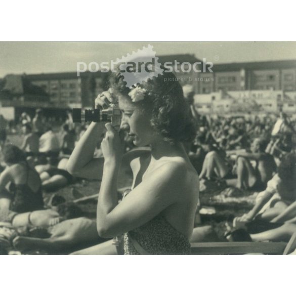 1950s. Germany. Young woman taking photo on the beach. Black and white original paper image, old photo. (2792488)