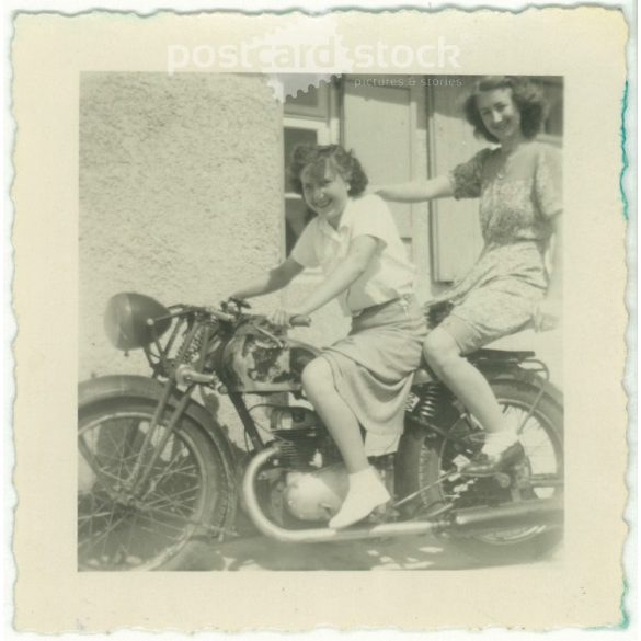 1950. Germany. Young ladies on a stationary motorcycle. The picture was taken by Foto-Uschold. Black and white original paper image, old photo. (2792489)