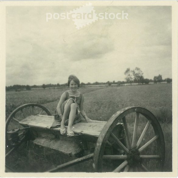 1963. Germany. Young lady on an agricultural machine. Black and white original paper image, old photo. (2792494)