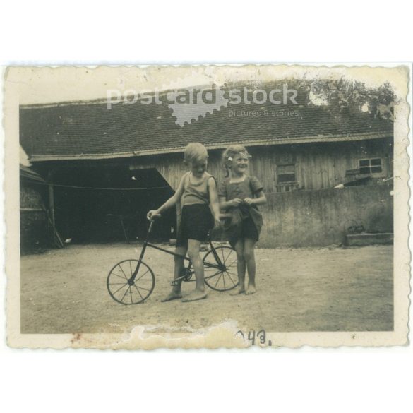 1943. Germany. Children on bicycles on a farm. The creator of the picture and the person on it are unknown. Black and white original paper image, old photo. (2792498)