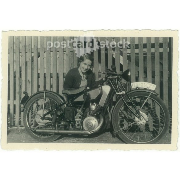 1936. Germany. Young lady with motorbike. The creator of the picture and the person on it are unknown. Black and white original paper image, old photo. (2792504)