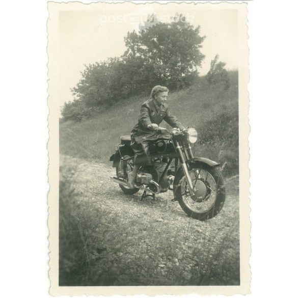 1953. Germany. Young lady with motorbike. The creator of the picture and the person on it are unknown. Black and white original paper image, old photo. (2792507)