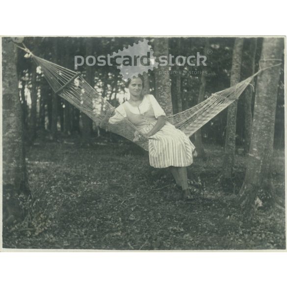 1922. Germany. Young lady on a forest hammock. The creator of the picture and the person on it are unknown. Black and white original paper image, old photo. (2792517)