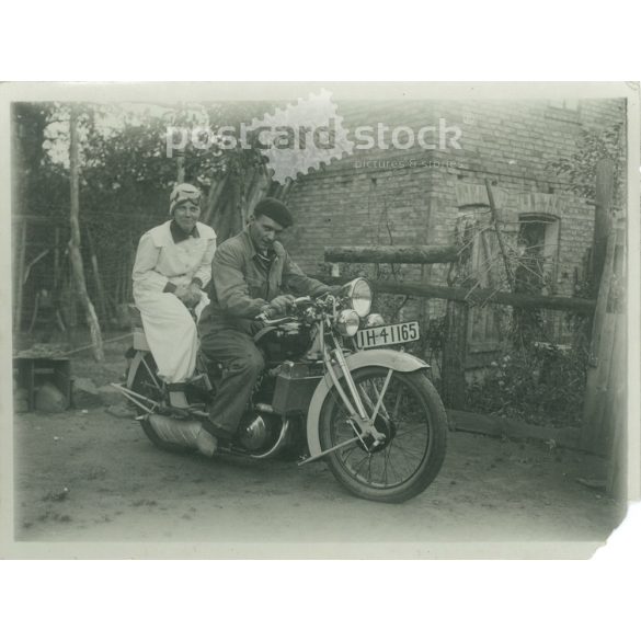 1920s. Germany. Young couple posing on a motorcycle. The creator of the picture and the identity of the people on it are unknown. Black and white original paper image, old photo. (2792518)