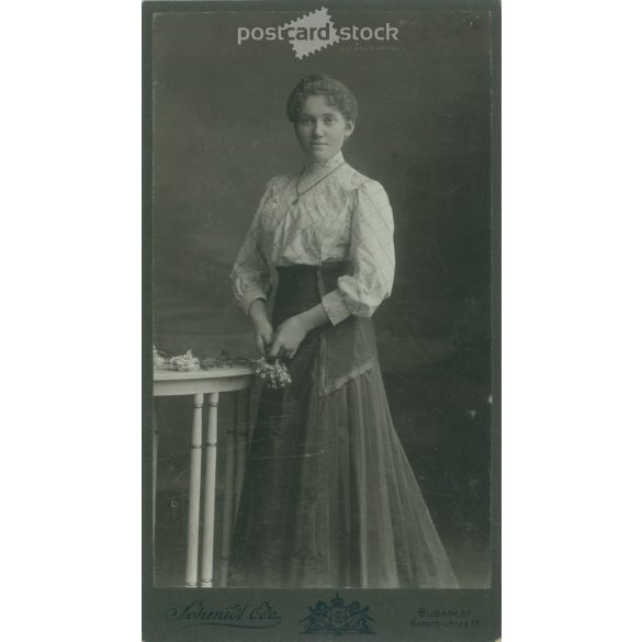 1910s. Studio photo of a young lady. The woman’s identity is unknown. The photo was taken in Schmidt Ede’s photography studio in Budapest. Old photo, original cabinet photo / hardback photo. (2792681)