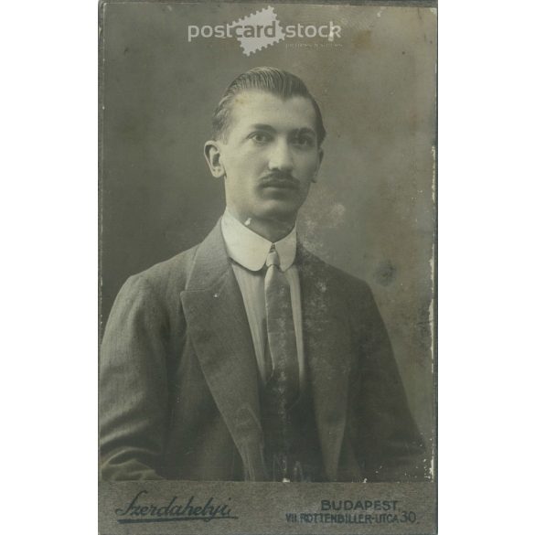 Early 1900s. Studio photo of a young man. The person in the picture is unknown. The work of the photography studio in Szerdahely. Budapest. Old photo, business card, CDV photo. (2792703)